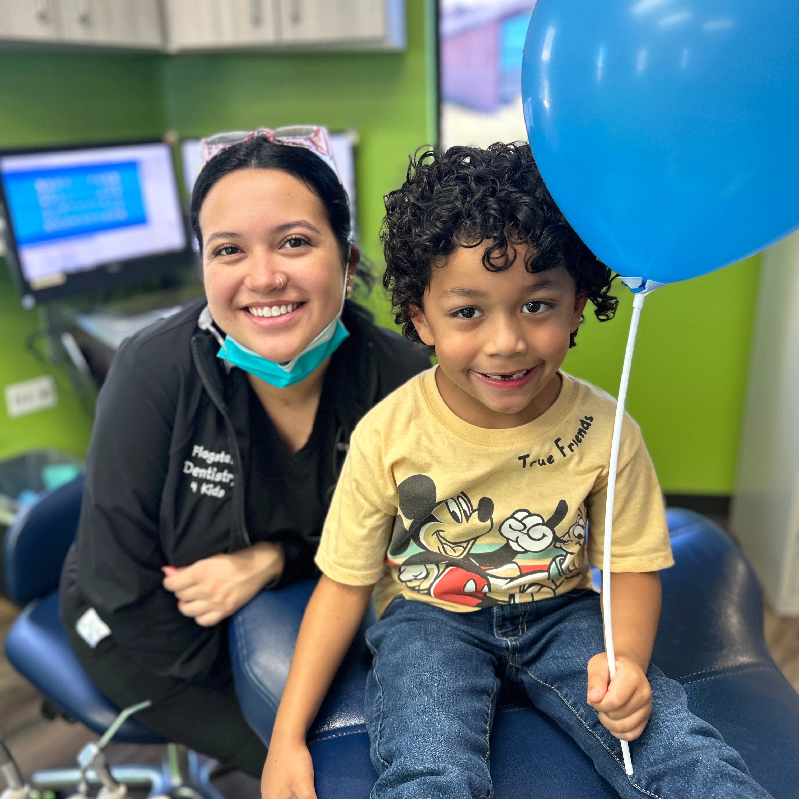Child holding a balloon in a dentists office